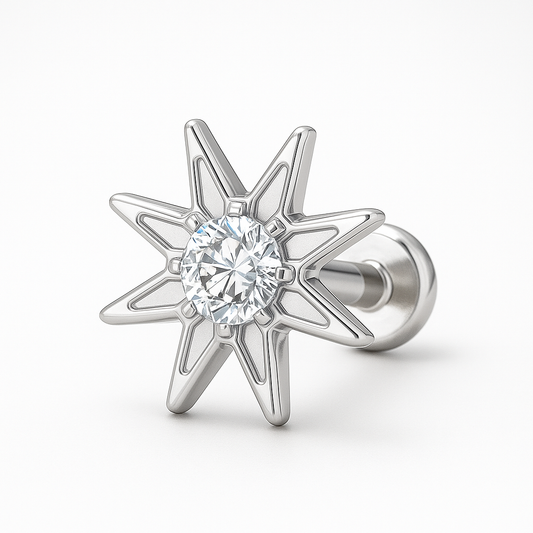 Silver star-shaped earring with a clear gemstone on a white background