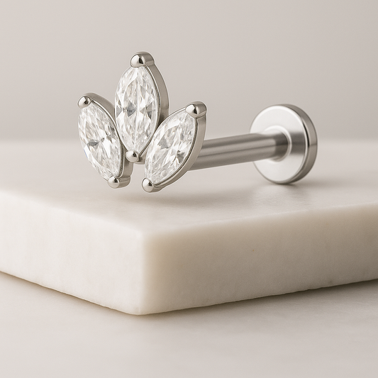Silver earring with clear gemstones on a light background