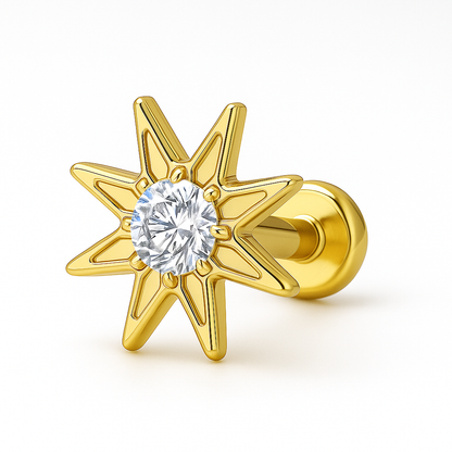 Gold star-shaped earring with a clear gemstone on a white background