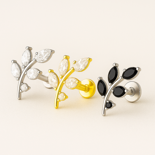 Three pairs of earrings with different designs on a light beige background