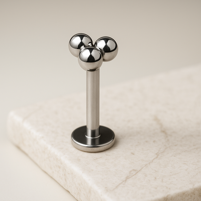 Metallic three-ball design on a beige background