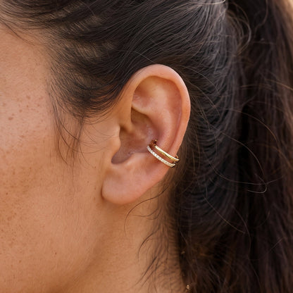 Womans ear showing double layer hoop in conch piercing