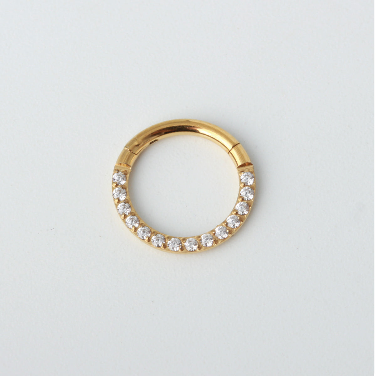 Elena surgical steel segment ring in gold with pavé cubic zirconia stones and hinged clicker closure
